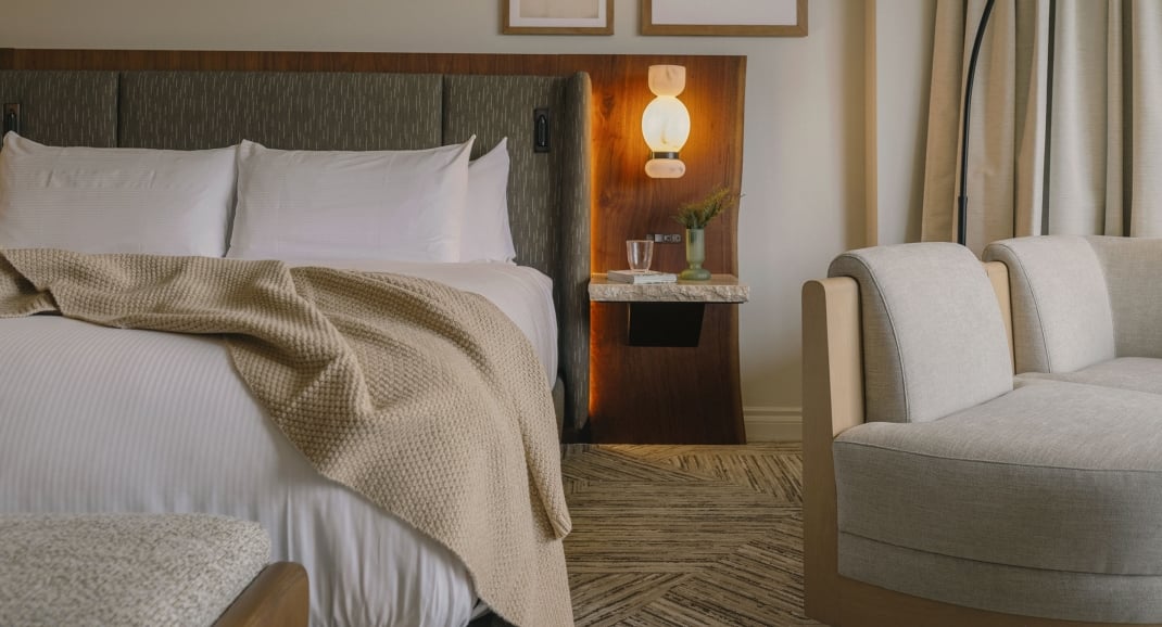 A cozy bed in a Classic Room at Rimrock Banff, Emblems Collection