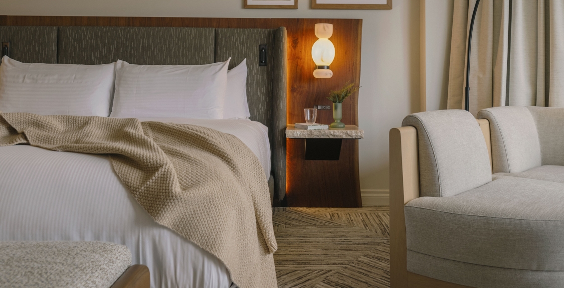 A cozy bed in a Classic Room at Rimrock Banff, Emblems Collection