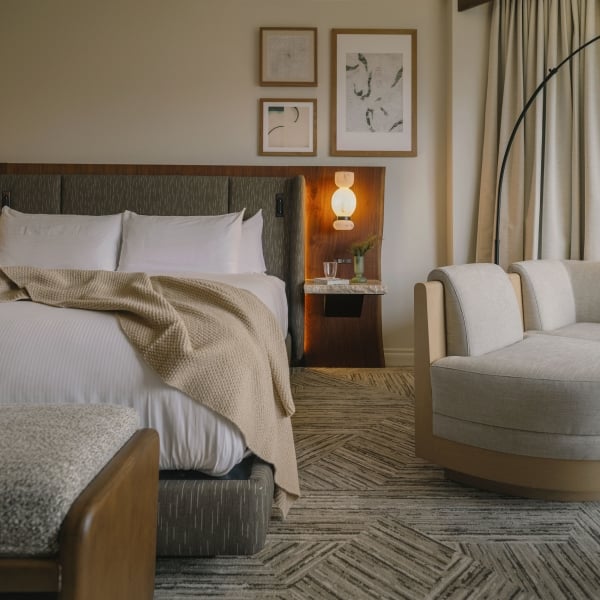 A cozy bed in a Classic Room at Rimrock Banff, Emblems Collection