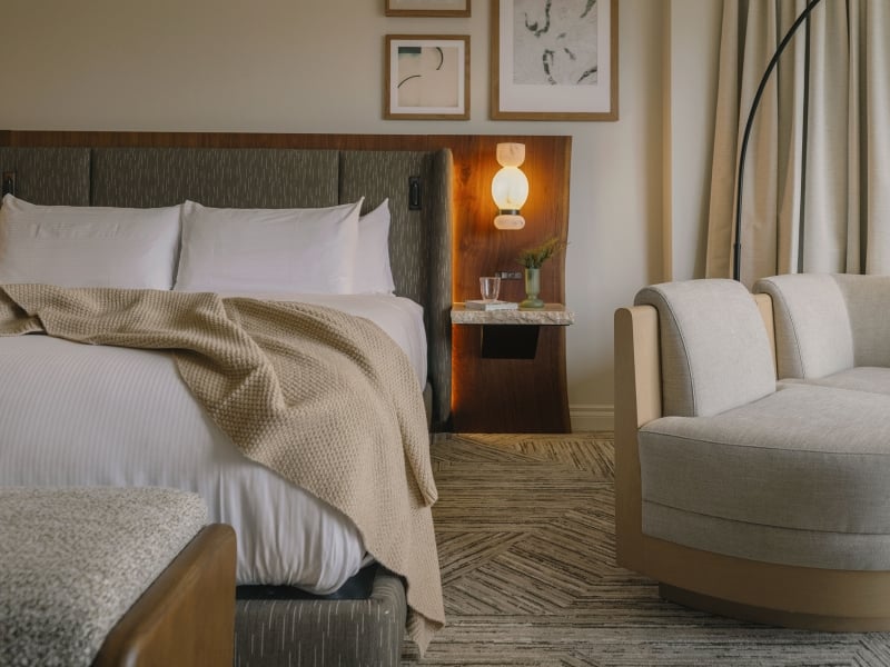 A cozy bed in a Classic Room at Rimrock Banff, Emblems Collection