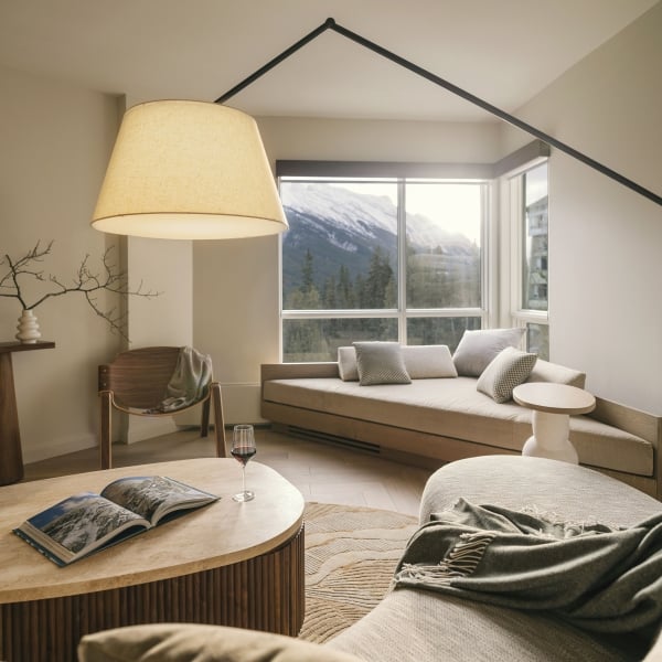 The living space of a Valley View Suite at Rimrock Banff with comfortable seating at expansive valley views
