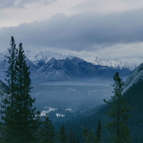 The View from a window at Rimrock Banff, with the Bow Valley below and tall mountains in the distance.