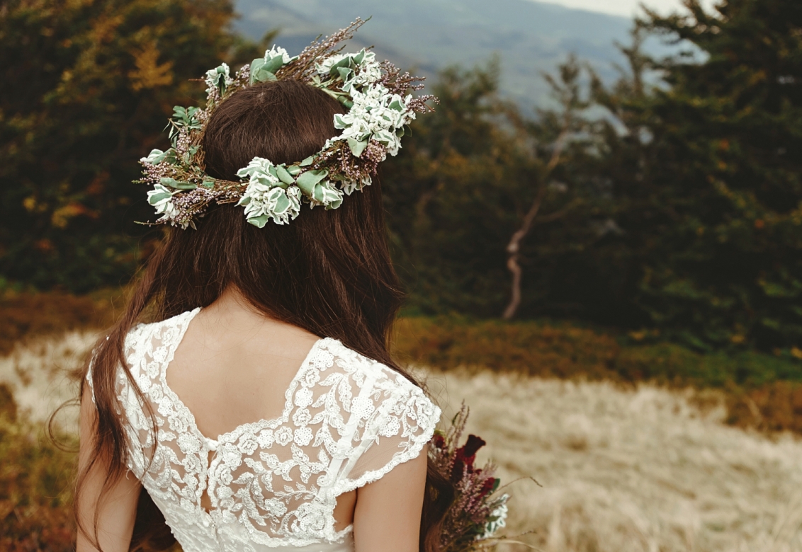 a bride looking away from the camera into the mountains in the distance.