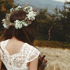 a bride looking away from the camera into the mountains in the distance.