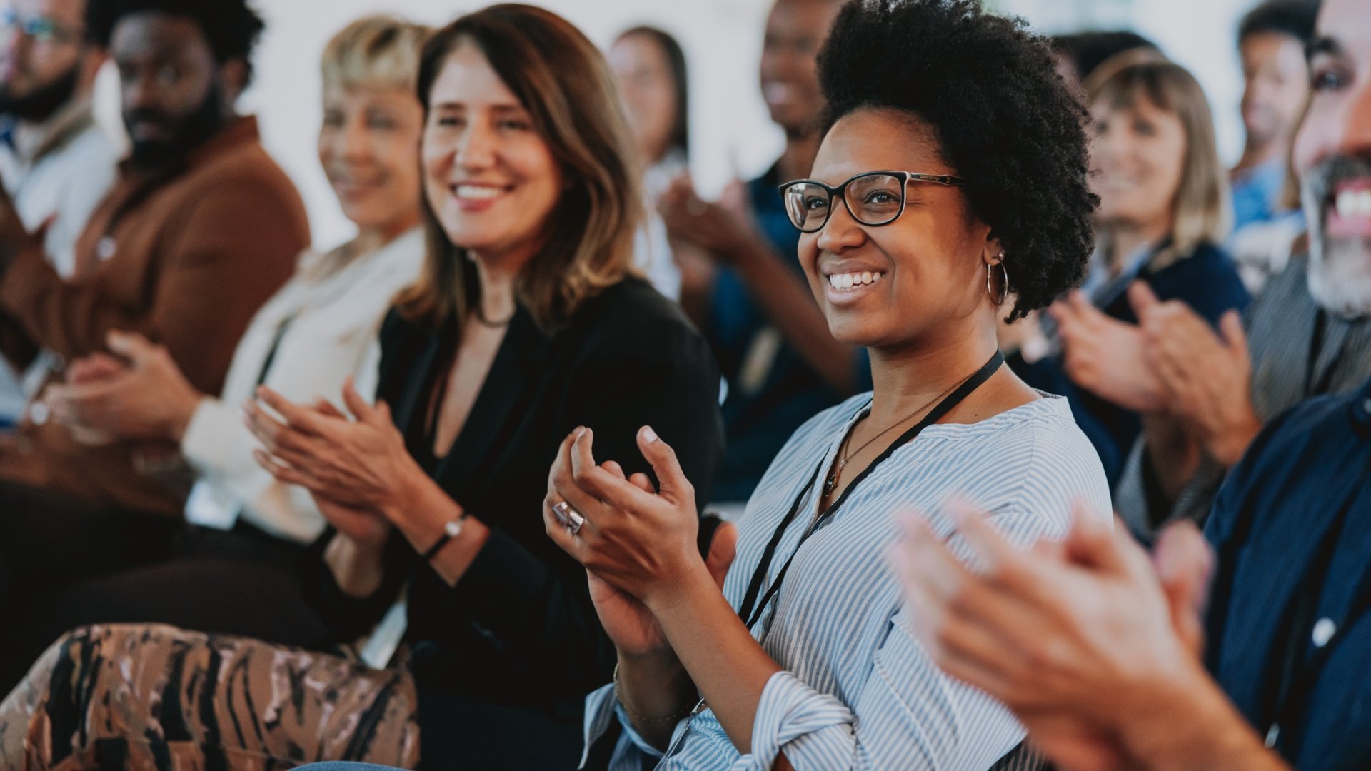 people clapping while at a conference